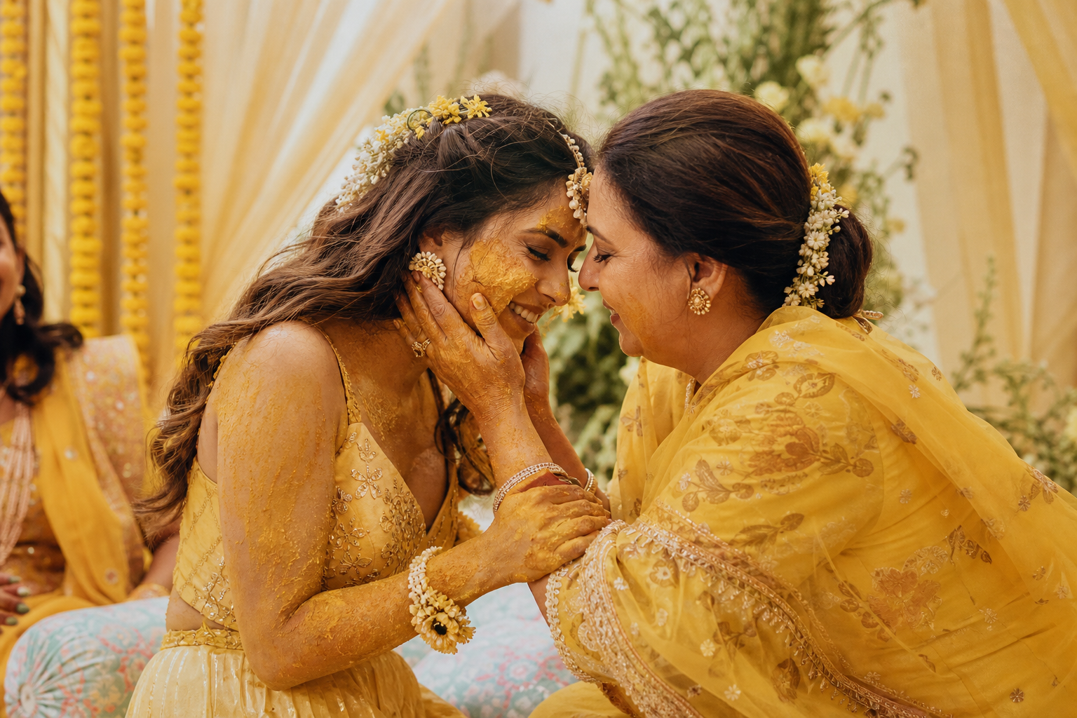 Bride sharing an emotional haldi moment with a close family member